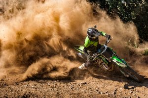 Motocross,Rider,Creates,A,Huge,Cloud,Of,Dust,And,Debris